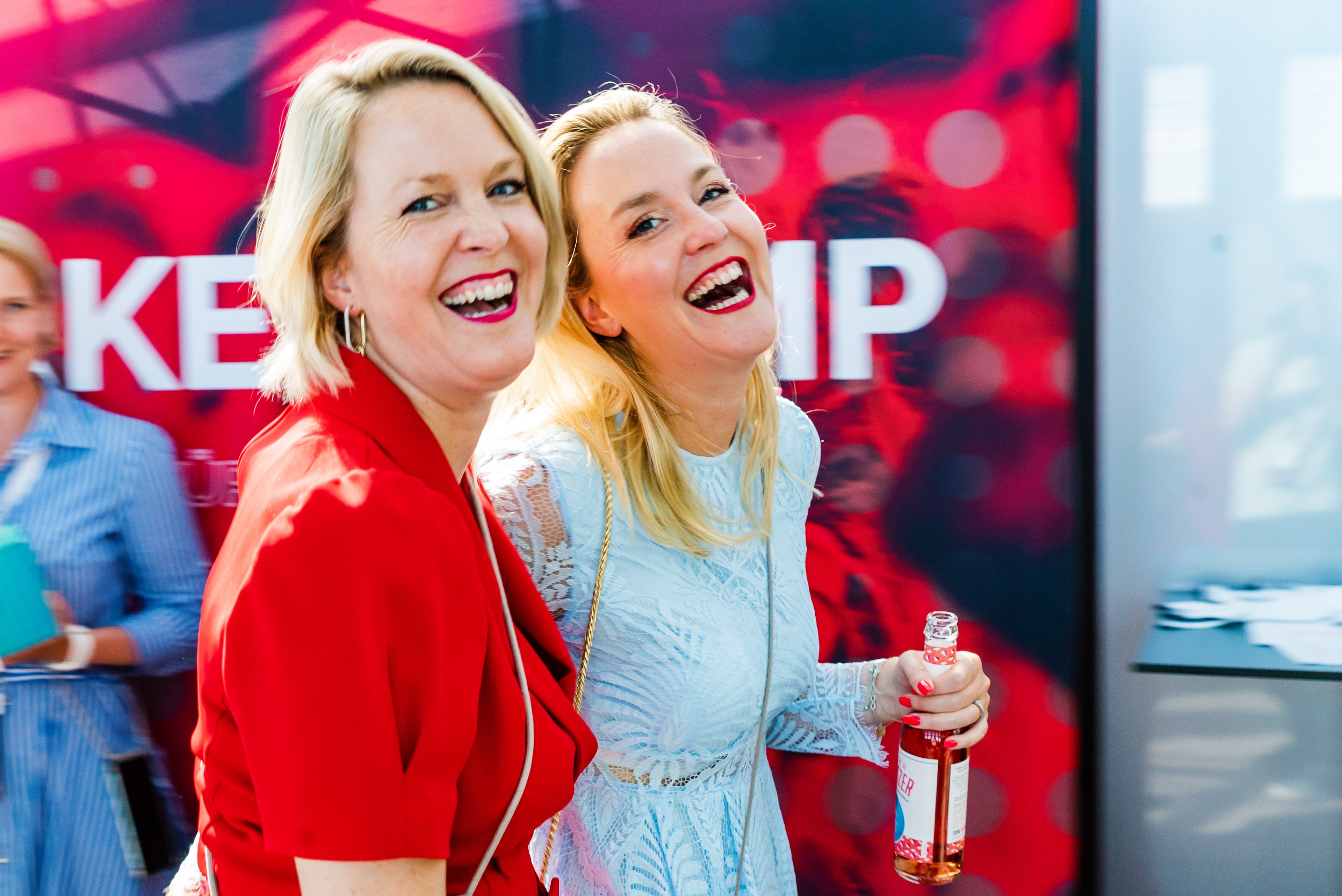 Event photography — two women laughing at a brand event